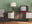 retro modern living room with green wall, sideboard and accent chair, lamp and vintage TV