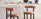 tips for choosing the perfect bar stool - image features 2 modern styling bar chairs with teracotta orange fabric, barrel style round back cushion, round seta, and black round legs in modern kitchen