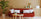 interior design trends blog header shows orange sofa in Scandi inspired room with round coffee table and pot plant