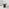 Penrose Black Round Dining Table & 4 Grey Beaumont Chairs