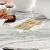 Novara White Marble Black Leg Round Dining Table & 4 Grey Milan Black Leg Chairs
