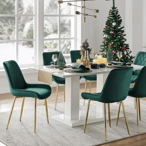 white high gloss table and green velvet dining chairs with gold legs dressed for christmas in green and gold accents