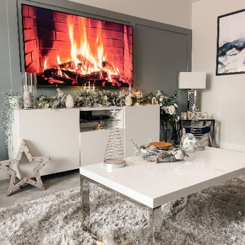 christmas living room with white high gloss and chrome coffee table dressed for christmas