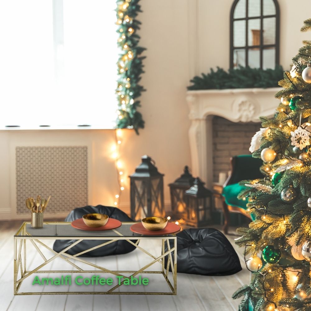 room decorated for christmas featuring large rectangular glass coffee table with gold geometric base, set with plates and cutlery, and two beanbags