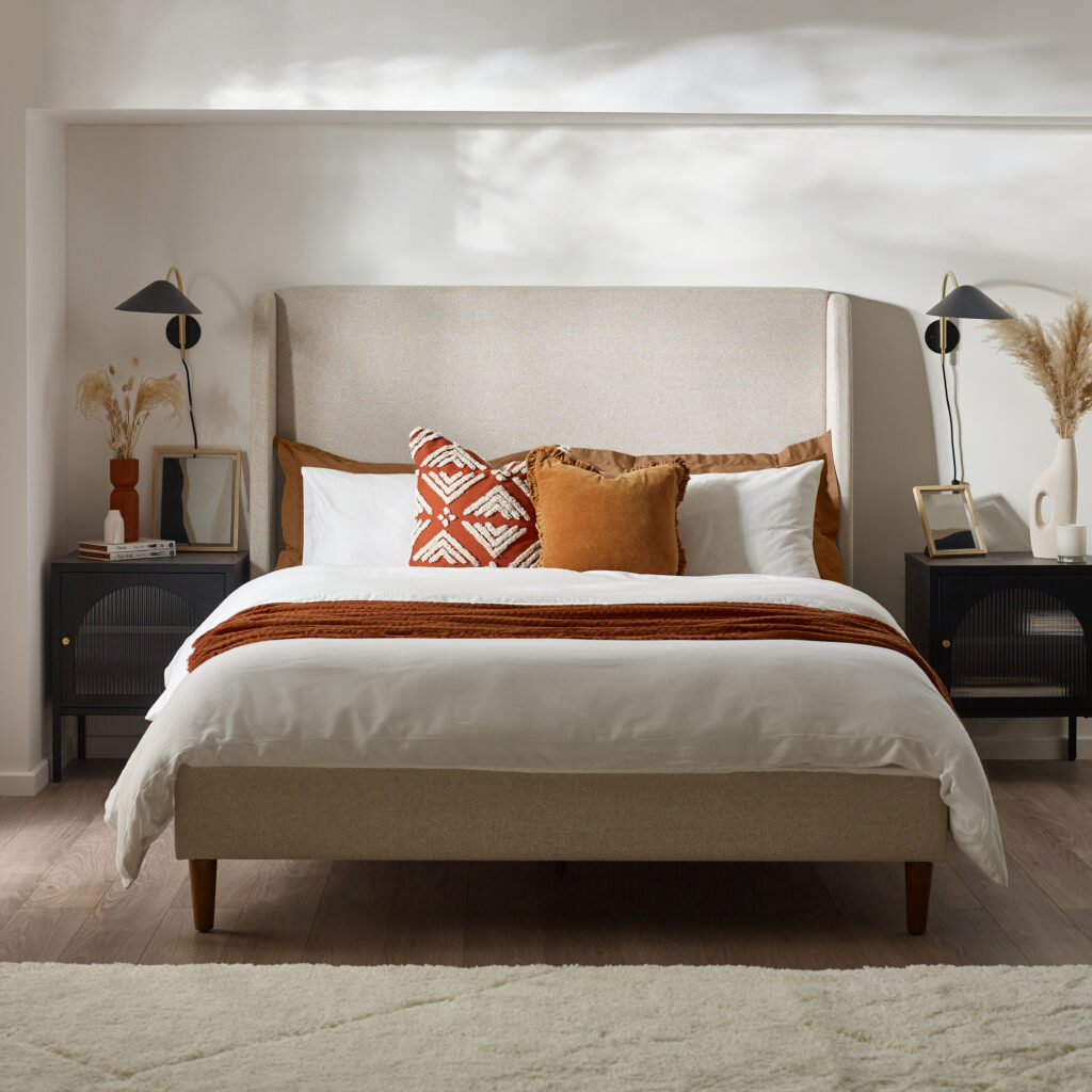 Linen look kingside bedframe with white and teracoota bed sheets in a Mediterranean Greek inspired bedroom 