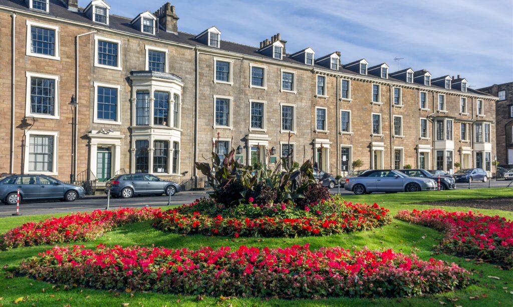 pretty street scene of terraced houses with formal gardens in foreground from Harrogate