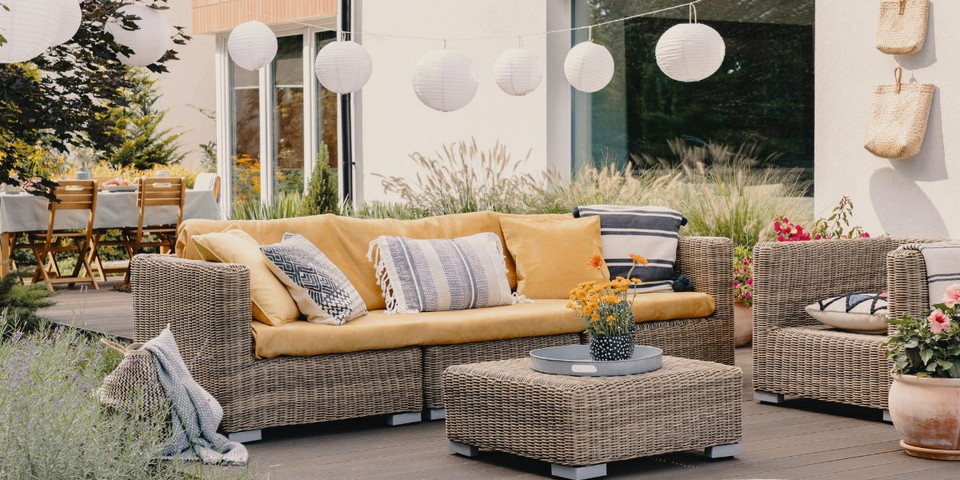 create a garden living room with rattan outdoor furniture