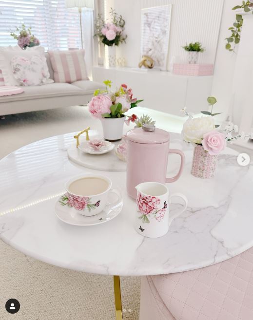 birght modern living room with white marble coffee table and floral tea set