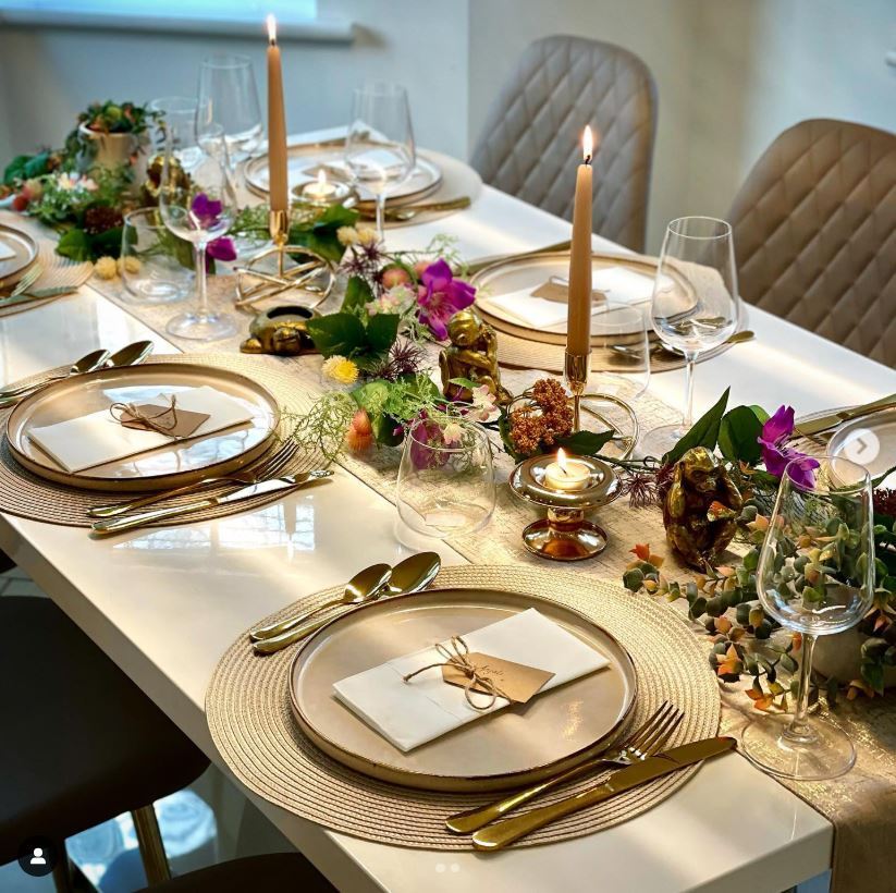 white gloss dining table with romantic floral tablescape and gold tableware for Valentine's dinner styling